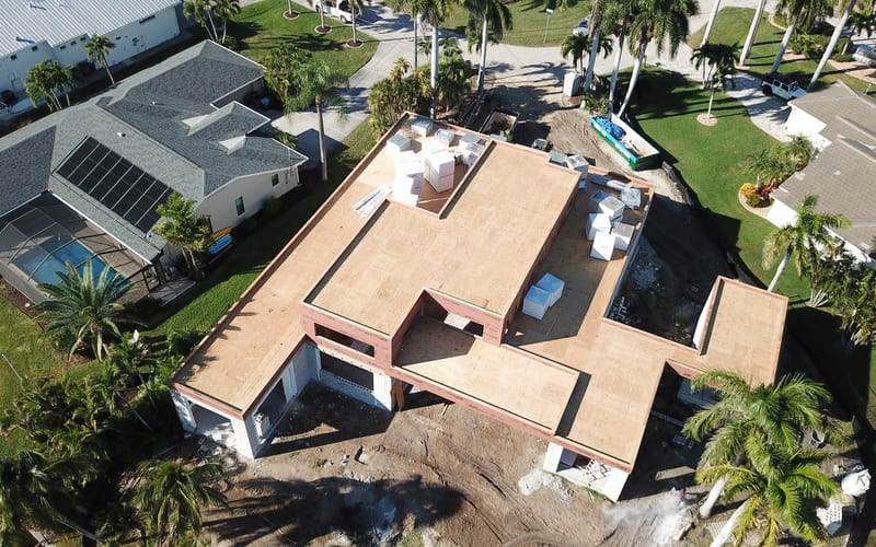 Storm damaged roof with missing shingles before repair